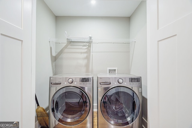 washroom with independent washer and dryer and laundry area