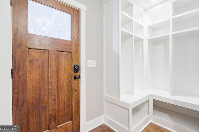 mudroom featuring baseboards and wood finished floors