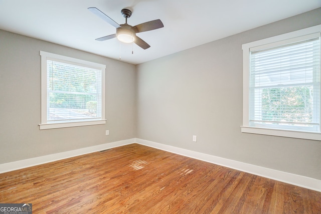 spare room featuring hardwood / wood-style flooring and ceiling fan