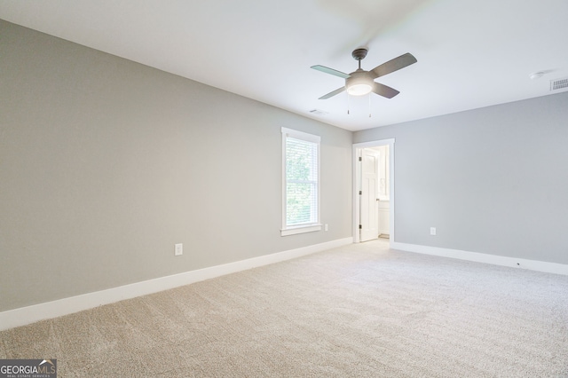 unfurnished room with ceiling fan and light carpet