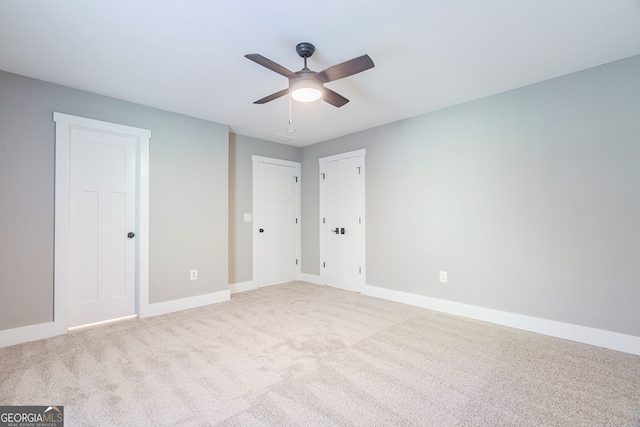 unfurnished bedroom with carpet flooring, baseboards, and a ceiling fan