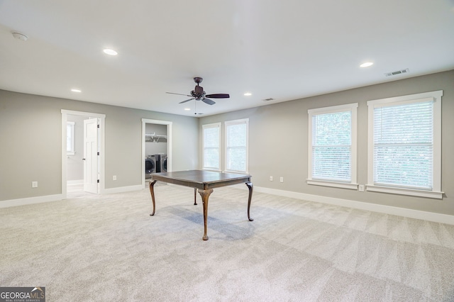 game room with light carpet, washer and clothes dryer, and ceiling fan