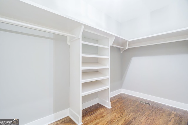 spacious closet featuring hardwood / wood-style flooring