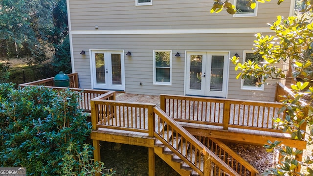 wooden deck featuring ceiling fan and french doors