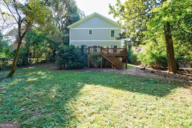 back of house with a yard, a wooden deck, fence, and stairs