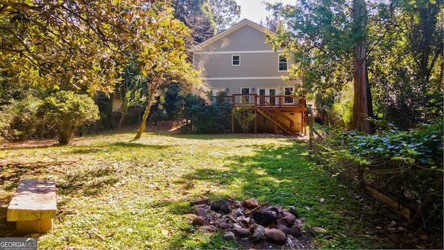 view of yard with stairs and a wooden deck
