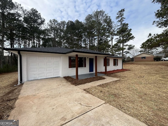 ranch-style home featuring a porch and a garage