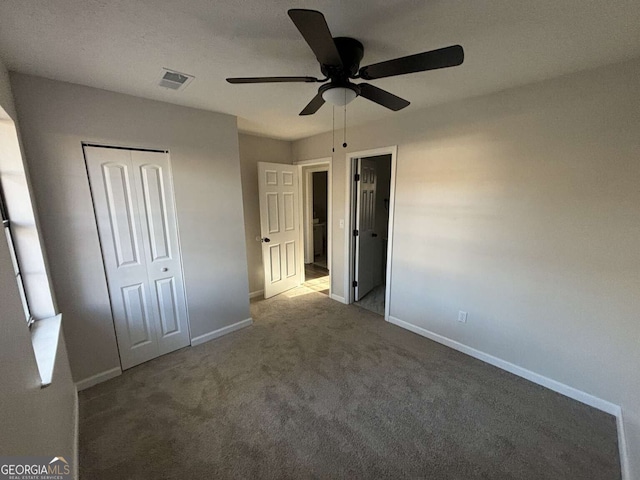 unfurnished bedroom featuring ceiling fan, carpet floors, and a closet