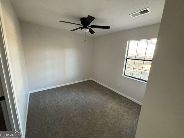 carpeted spare room with ceiling fan