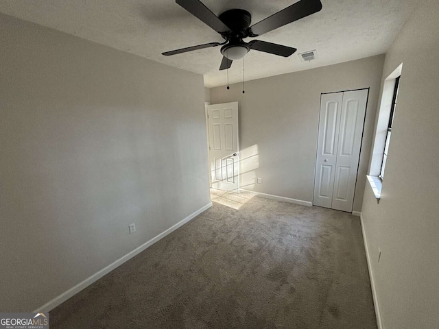 unfurnished bedroom featuring carpet floors, a closet, and ceiling fan