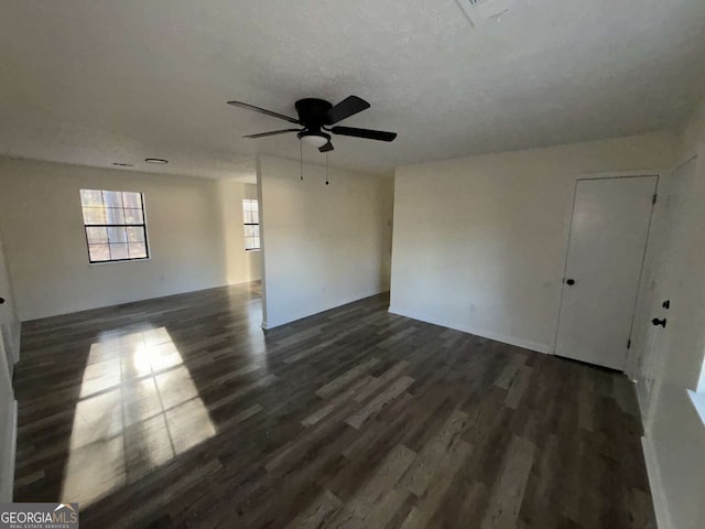 unfurnished room featuring ceiling fan and dark wood-type flooring