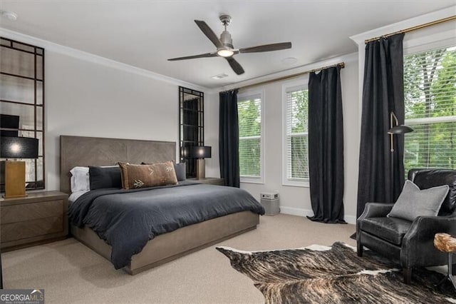 bedroom with ceiling fan, crown molding, and carpet flooring