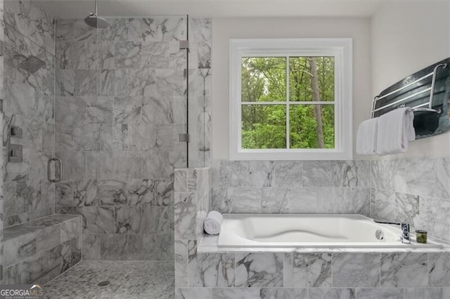 bathroom featuring separate shower and tub