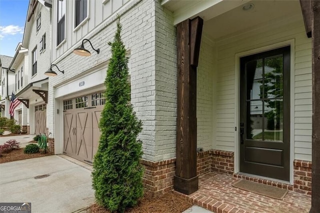 doorway to property with a garage