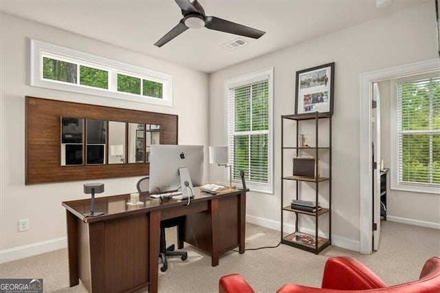 carpeted office featuring ceiling fan