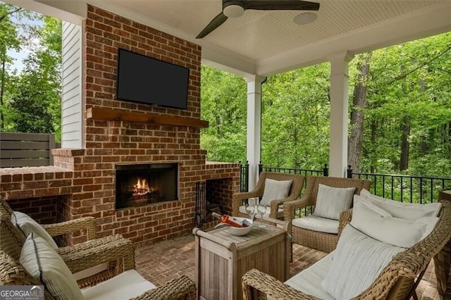 view of patio / terrace featuring an outdoor brick fireplace and ceiling fan