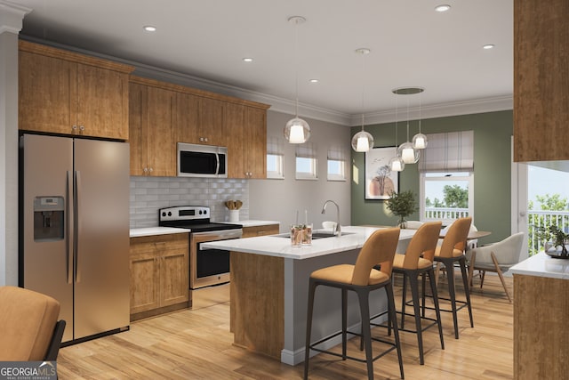 kitchen with sink, crown molding, hanging light fixtures, light wood-type flooring, and stainless steel appliances