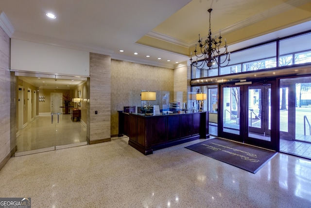 welcome area with french doors and a notable chandelier