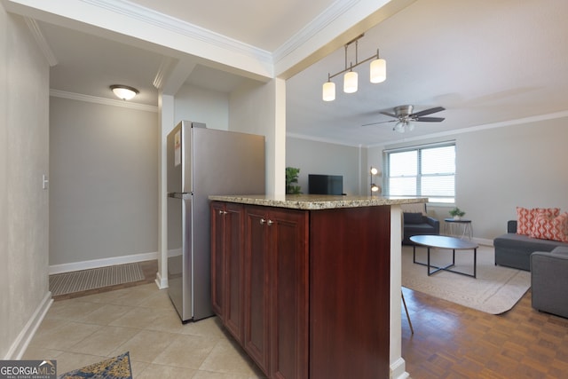 kitchen featuring light stone countertops, stainless steel fridge, ceiling fan, and crown molding