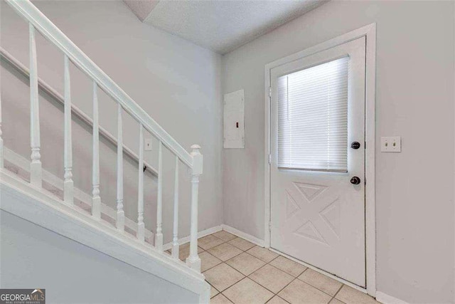 foyer entrance with light tile patterned floors