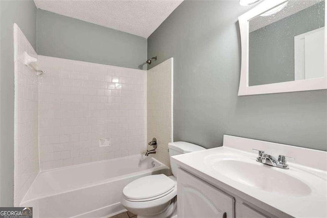 full bathroom with vanity, a textured ceiling, toilet, and tiled shower / bath combo