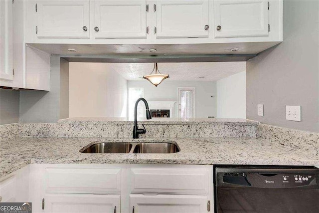 kitchen with white cabinetry, dishwasher, and sink