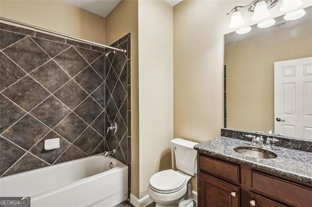 full bathroom featuring toilet, vanity, and tiled shower / bath