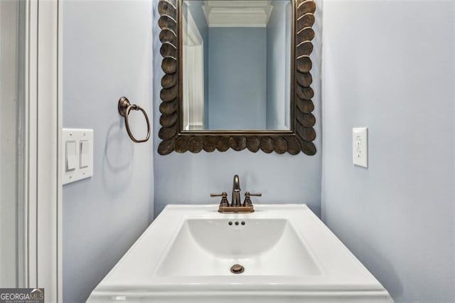 bathroom featuring crown molding and sink