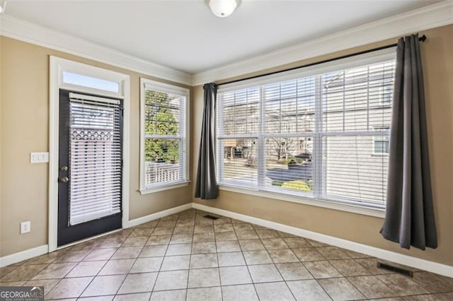 interior space with tile patterned floors and crown molding