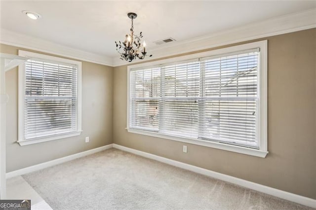 unfurnished room featuring carpet floors, crown molding, a wealth of natural light, and a notable chandelier