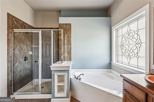 bathroom featuring vanity and independent shower and bath