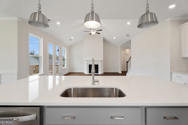 kitchen with sink, an island with sink, and pendant lighting