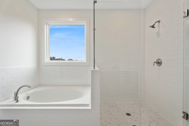 bathroom featuring independent shower and bath