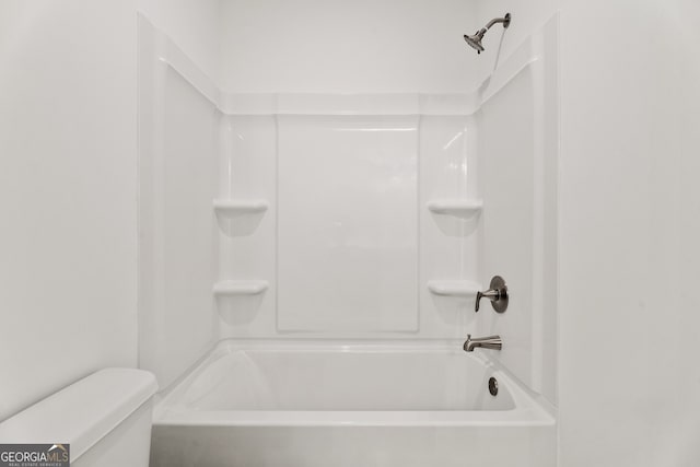 bathroom with shower / bathing tub combination and toilet