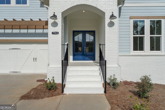 doorway to property featuring a garage and french doors