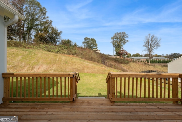 wooden deck with a lawn