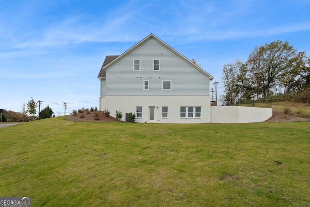 rear view of property with a lawn and central air condition unit