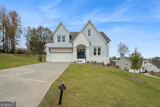 view of front of property featuring a front lawn and a garage