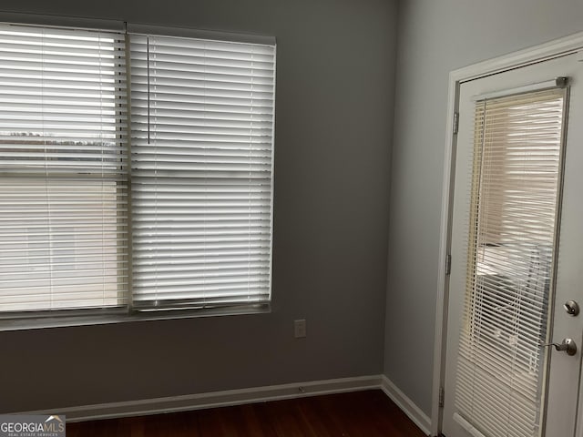 spare room with dark hardwood / wood-style flooring