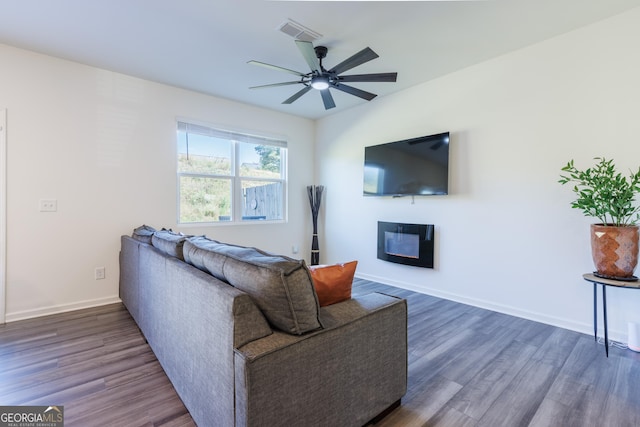 living room featuring dark hardwood / wood-style floors and ceiling fan