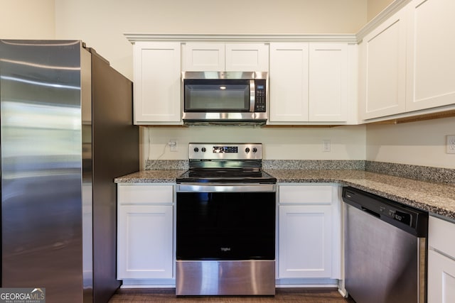 kitchen featuring stone countertops, white cabinetry, and stainless steel appliances