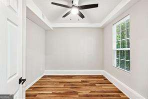 interior space with ceiling fan and wood-type flooring