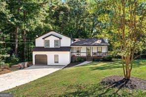 split level home with a front yard and a garage