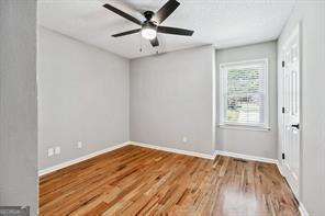 empty room with hardwood / wood-style floors and ceiling fan