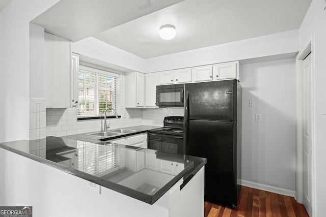 kitchen with sink, backsplash, kitchen peninsula, white cabinets, and black appliances