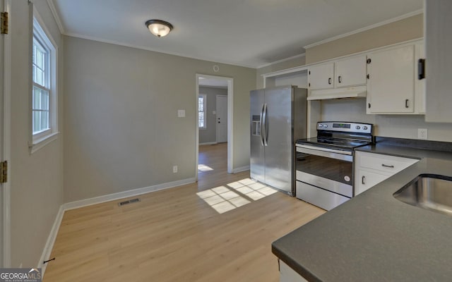 kitchen featuring white cabinets, stainless steel appliances, plenty of natural light, and light hardwood / wood-style floors