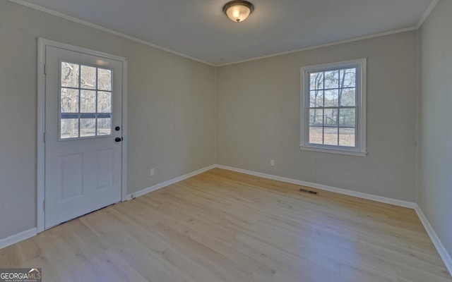 interior space with crown molding and light hardwood / wood-style flooring