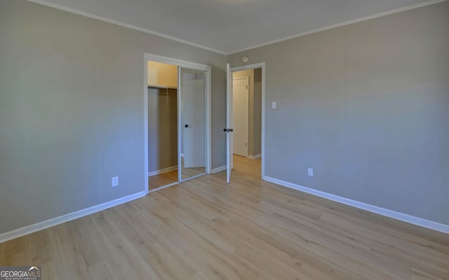 unfurnished bedroom featuring light hardwood / wood-style floors, a closet, and ornamental molding