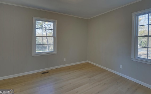 unfurnished room with light hardwood / wood-style floors and ornamental molding