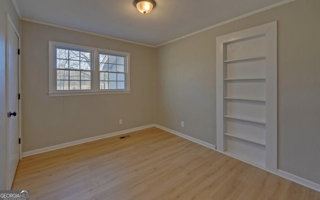 unfurnished bedroom with light wood-type flooring and ornamental molding